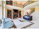 Bright living room with floor-to-ceiling windows, a fireplace, and comfortable seating at 805 Cog Hl, Mcdonough, GA 30253