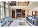 Bright living room featuring floor-to-ceiling windows, a fireplace, and comfortable seating at 805 Cog Hl, Mcdonough, GA 30253