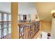 A great view of the loft area with wooden floors, an iron railing, and a view into the room below at 805 Cog Hl, Mcdonough, GA 30253