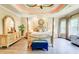 Inviting main bedroom with four-poster bed, ceiling fan, tray ceiling, hardwood floors, and ample natural light at 805 Cog Hl, Mcdonough, GA 30253