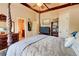 Bedroom featuring a dark wooden four-poster bed and a private ensuite bathroom at 805 Cog Hl, Mcdonough, GA 30253