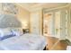 Cozy main bedroom with stylish decor, hardwood floors, and ensuite bathroom access at 805 Cog Hl, Mcdonough, GA 30253