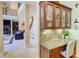 Built-in office space next to living room with custom cabinets, granite countertop and chair at 805 Cog Hl, Mcdonough, GA 30253
