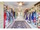 Massive walk in closet with hanging space, built in shelves and a central rug at 805 Cog Hl, Mcdonough, GA 30253