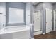 Bathroom with soaking tub, and glass shower, complete with modern fixtures at 132 Berkleigh Trails Dr, Hiram, GA 30141