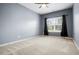Spacious bedroom features a large window with natural light, neutral carpet, and painted walls at 132 Berkleigh Trails Dr, Hiram, GA 30141