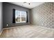 Bright bedroom features neutral carpet, a large window, dark curtains, and modern wallpaper at 132 Berkleigh Trails Dr, Hiram, GA 30141