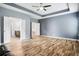 Large main bedroom with tray ceiling and multiple entries to the ensuite bath and closet at 132 Berkleigh Trails Dr, Hiram, GA 30141