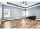 A spacious bedroom with tray ceilings, wood floors, and large windows offering natural light at 132 Berkleigh Trails Dr, Hiram, GA 30141