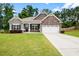 Charming single-Gathering home featuring a well-manicured lawn and inviting front entrance at 132 Berkleigh Trails Dr, Hiram, GA 30141
