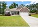 Charming single-Gathering home boasts stone accents, a two-car garage, and a well-manicured front lawn at 132 Berkleigh Trails Dr, Hiram, GA 30141
