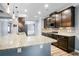 Modern kitchen features dark wood cabinets, granite countertops, stainless appliances, and pendant lighting at 132 Berkleigh Trails Dr, Hiram, GA 30141