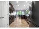A kitchen features stainless steel appliances, granite countertops and dark brown cabinets at 132 Berkleigh Trails Dr, Hiram, GA 30141