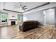 Spacious living room with hardwood floors, modern fan, fireplace, and comfortable seating at 132 Berkleigh Trails Dr, Hiram, GA 30141