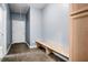 Bright mudroom features wood-look flooring, convenient bench, and direct access to the exterior at 132 Berkleigh Trails Dr, Hiram, GA 30141