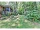 Verdant backyard with brick home, screened porch, and mature trees providing privacy at 1970 Fisher Ne Trl, Atlanta, GA 30345