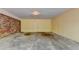 Unfinished basement with brick accent wall and concrete floors ready for customization at 1970 Fisher Ne Trl, Atlanta, GA 30345