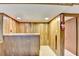 Paneled basement featuring a bar area, neutral carpet, and access to other rooms in the house at 1970 Fisher Ne Trl, Atlanta, GA 30345