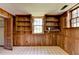 Basement featuring wood-paneled walls, tiled floor, built-in shelving, and an exterior view at 1970 Fisher Ne Trl, Atlanta, GA 30345