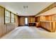 Spacious basement with wood paneled walls, a built-in bar, and walk out access at 1970 Fisher Ne Trl, Atlanta, GA 30345