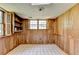 Basement with a checkered tile floor, wood-paneled walls, built-in shelving, and natural light at 1970 Fisher Ne Trl, Atlanta, GA 30345