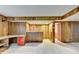 Spacious basement with paneled walls, a built-in desk and red drawers, and access to other rooms at 1970 Fisher Ne Trl, Atlanta, GA 30345