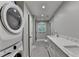 Bathroom with long countertop, a stackable washer/dryer, and a window with natural light at 1970 Fisher Ne Trl, Atlanta, GA 30345