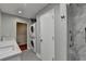 Well-lit bathroom features a double vanity, stackable washer/dryer, and a glass-enclosed shower at 1970 Fisher Ne Trl, Atlanta, GA 30345