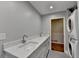 Modern bathroom features a double vanity, a stackable washer/dryer, and tiled floors at 1970 Fisher Ne Trl, Atlanta, GA 30345