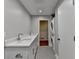 Bright bathroom with double vanity, marble countertop, tiled floor, and stackable washer/dryer at 1970 Fisher Ne Trl, Atlanta, GA 30345