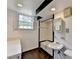 Well-lit bathroom with black and white tiled floors, a shower, and a large window for natural light at 1970 Fisher Ne Trl, Atlanta, GA 30345