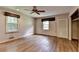 Bedroom with hardwood floors, closet with louvered door, and two windows with woven shades at 1970 Fisher Ne Trl, Atlanta, GA 30345