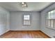 Bedroom featuring hardwood floors, bright walls, standard closet, window with white shutters and ceiling fan at 1970 Fisher Ne Trl, Atlanta, GA 30345