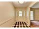 Welcoming entryway with black and white checkered tile flooring and decorative front door at 1970 Fisher Ne Trl, Atlanta, GA 30345