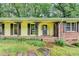 Inviting front porch features brick accents, decorative iron posts and stone pathway to the front door at 1970 Fisher Ne Trl, Atlanta, GA 30345
