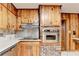 Kitchen with stainless appliances, wooden cabinets and a brick column at 1970 Fisher Ne Trl, Atlanta, GA 30345