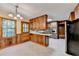 Well-lit kitchen with wood cabinets, tiled floors, and stainless-steel appliances at 1970 Fisher Ne Trl, Atlanta, GA 30345