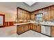 Sunlit kitchen with white countertops, knotty pine cabinets, and tiled floor at 1970 Fisher Ne Trl, Atlanta, GA 30345