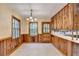 Bright kitchen featuring wood cabinets, tiled floors, and natural light from large windows at 1970 Fisher Ne Trl, Atlanta, GA 30345
