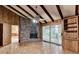 Open living room with brick fireplace, sliding glass doors, and wood paneled walls at 1970 Fisher Ne Trl, Atlanta, GA 30345