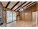 Living room featuring beamed ceilings, a brick fireplace, and sliding doors to a screened porch at 1970 Fisher Ne Trl, Atlanta, GA 30345