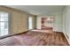 Spacious living room with classic wall paneling, carpet flooring, and view to the dining room at 1970 Fisher Ne Trl, Atlanta, GA 30345