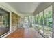 Enclosed screened porch with brick accent wall and mosaic tile flooring overlooks lush greenery at 1970 Fisher Ne Trl, Atlanta, GA 30345