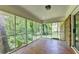 Spacious screened-in porch with brick wall and mosaic tile floor offering serene outdoor views at 1970 Fisher Ne Trl, Atlanta, GA 30345