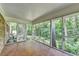 Relaxing screened porch with brick wall and mosaic tile flooring with view of trees at 1970 Fisher Ne Trl, Atlanta, GA 30345