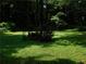 Lush green backyard surrounded by mature trees and foliage, providing a private outdoor space at 2765 Rollingwood Se Ln, Atlanta, GA 30316
