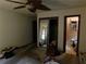 Bedroom view including mirrored closet doors, ensuite bathroom, ceiling fan, and doorway at 2765 Rollingwood Se Ln, Atlanta, GA 30316