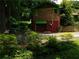 Two story building with a brick upper level and a red lower level with a garage door at 2765 Rollingwood Se Ln, Atlanta, GA 30316