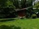 Charming home with green trim surrounded by lush greenery and mature trees at 2765 Rollingwood Se Ln, Atlanta, GA 30316