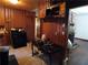Rustic kitchen with wood paneled walls, dark appliances, and brick-surround fireplace at 2765 Rollingwood Se Ln, Atlanta, GA 30316